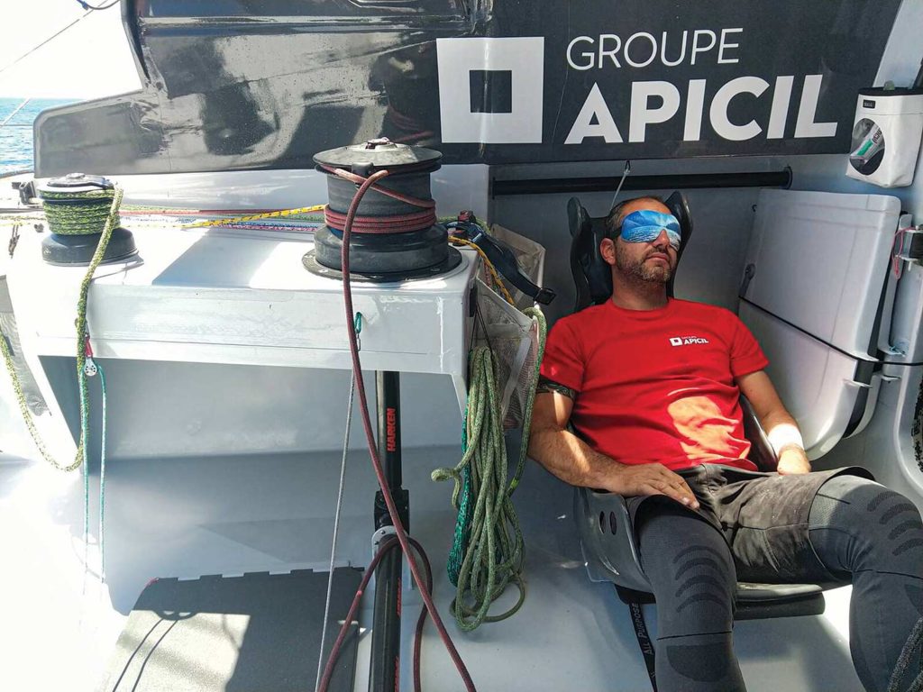 A man resting on a sailboat.