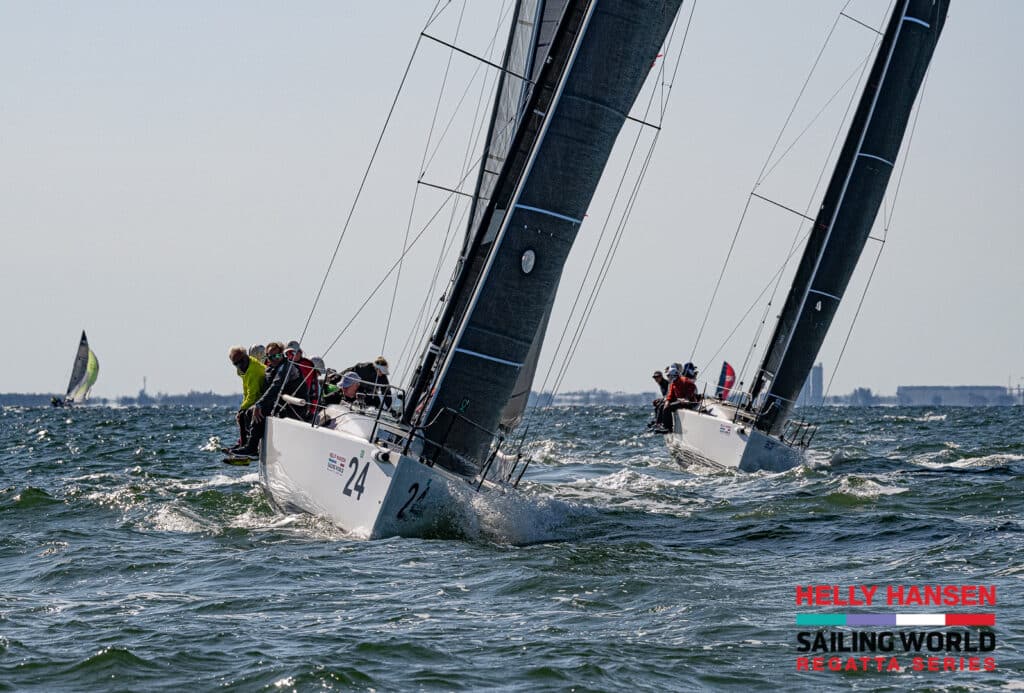 two sailboats racing side by side in strong winds in florida