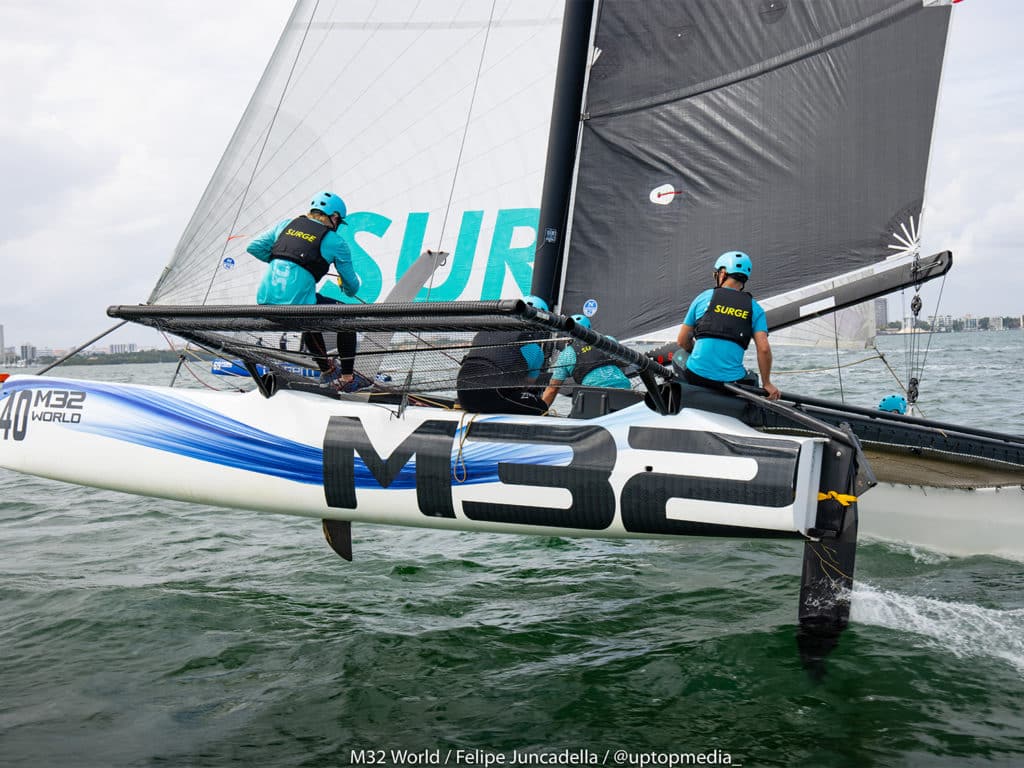 A sailboat racing team on the water.